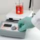 Globe Scientific GHS-550HSP Digital Hotplate Stirrer with Glass Ceramic Top Plate and RS232 port - A Hand Adjusting the Contol Knob with Beaker, Temperature Sensor and Support Stand (Beaker, Temperature Sensor and Sensor Support Stand are sold separately)